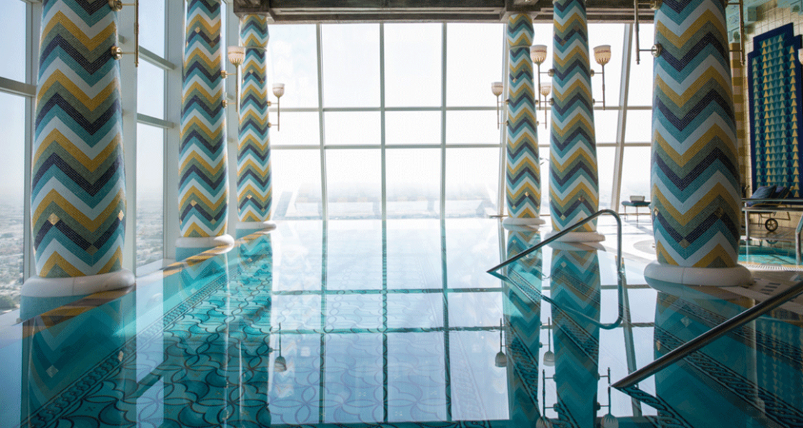 The opulent, indoor infinity pool lined with shimmering mosaic tiles. Photograph by Walter Shintani.
