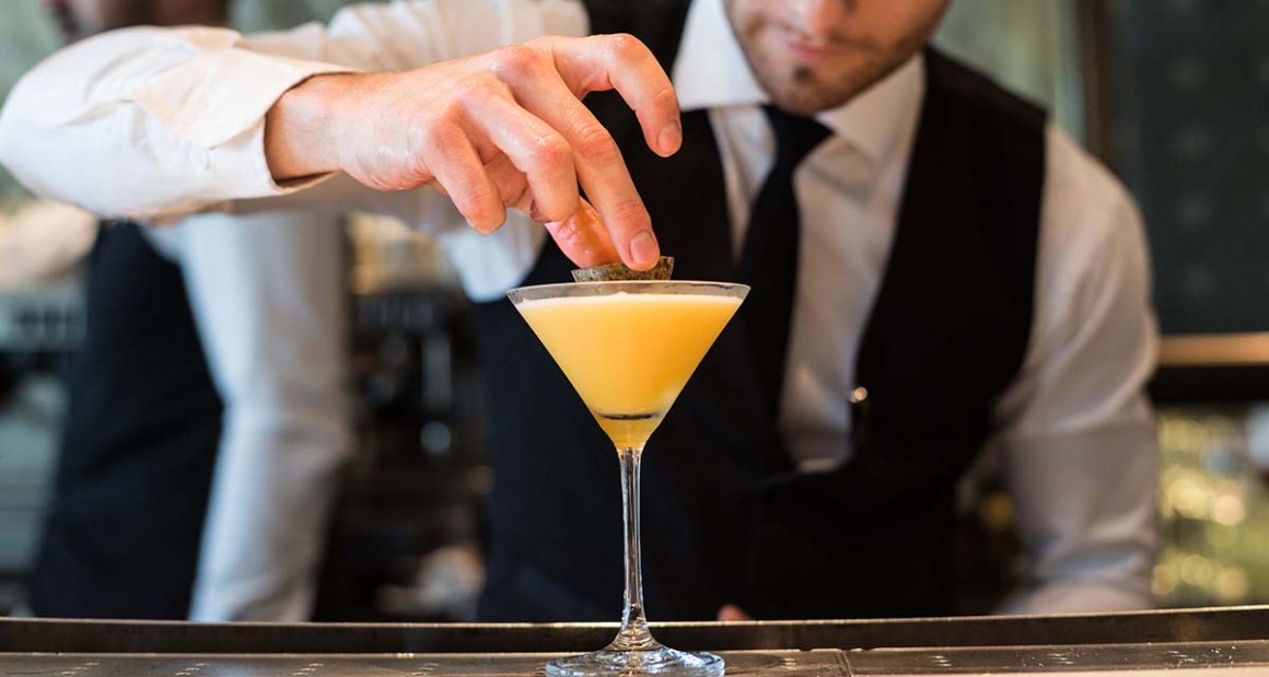 A bartender prepares a passionfruit martini. Photograph by Walter Shintani.