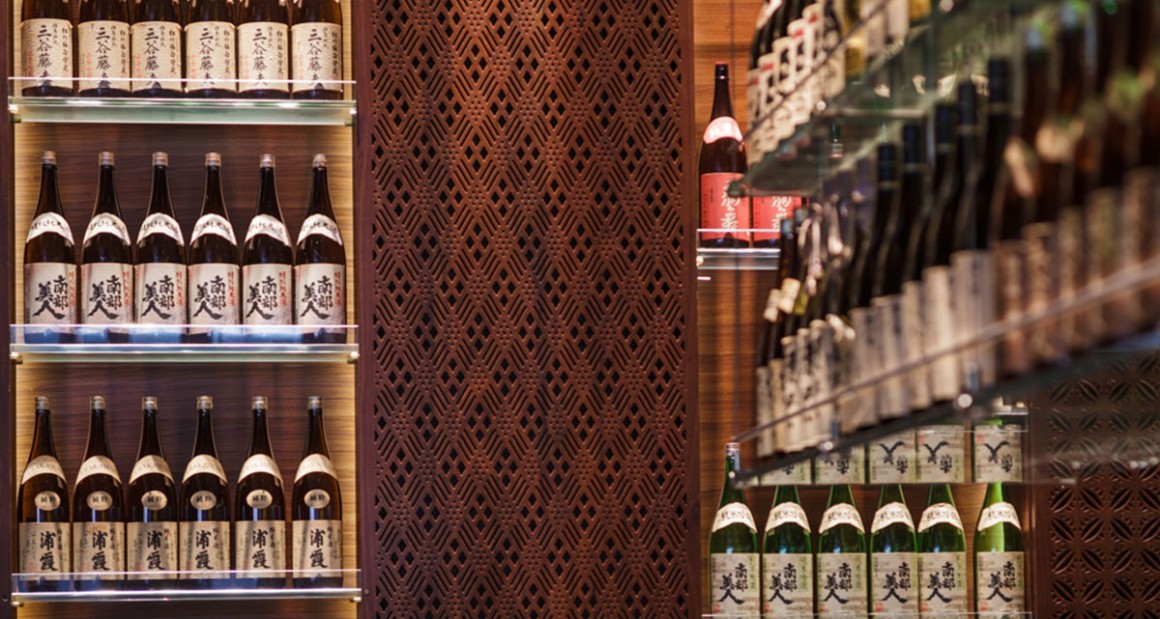 Shelves of sake line the walls. Photograph by Walter Shintani.