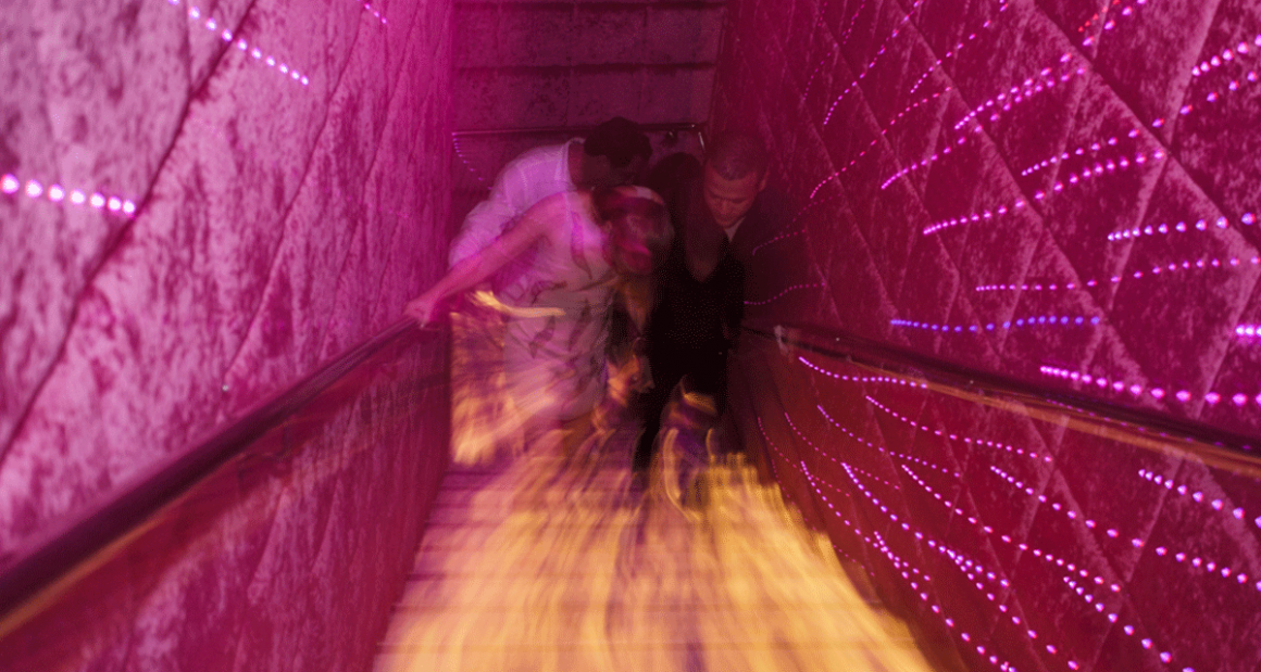 Festive lights line a stairwell. Photograph by Walter Shintani.