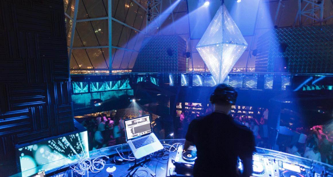 A DJ surveys the crowd. Photograph by Walter Shintani.

